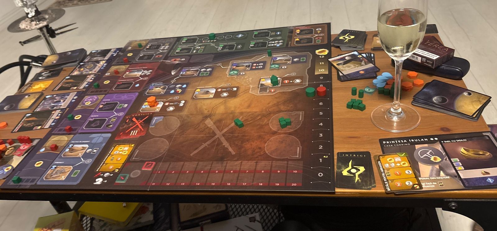 The Dune board on a low table late at night, with a glass at the edge